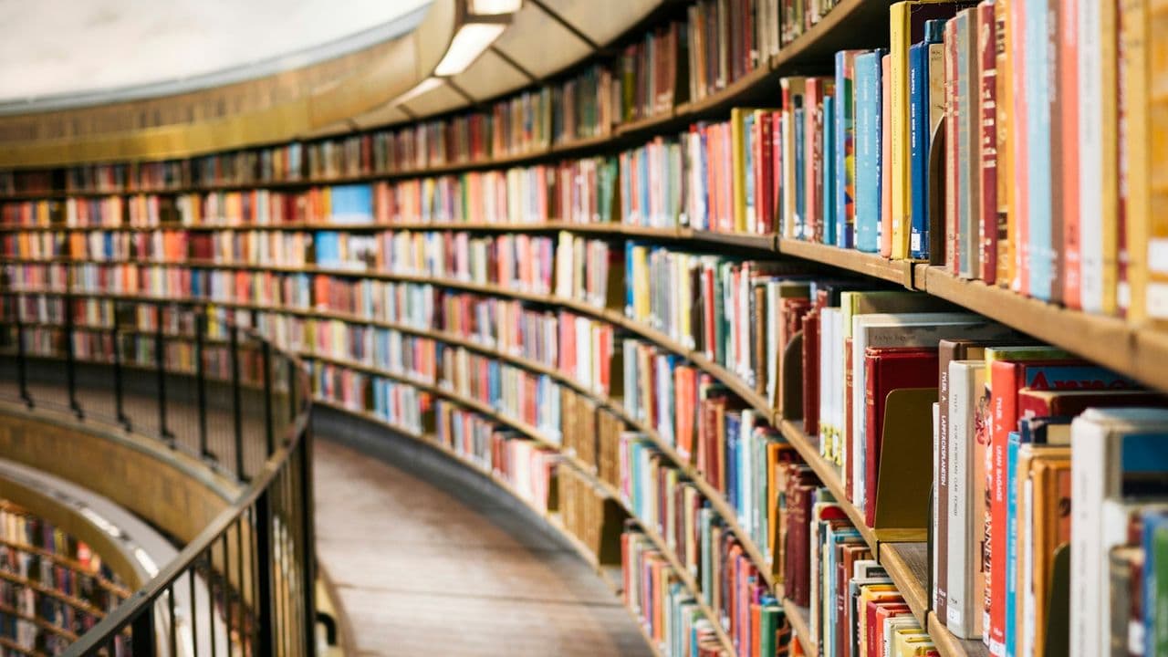 Estantes curvos llenos de libros en una biblioteca